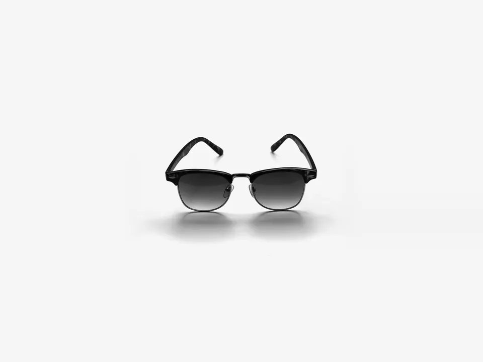 Black half-frame sunglasses with gradient lenses on a white background